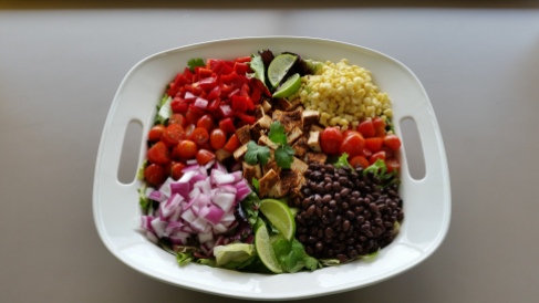 Southwest Chicken Salad with black beans, onions, red pepper, corn, chicken, lime and cherry tomato